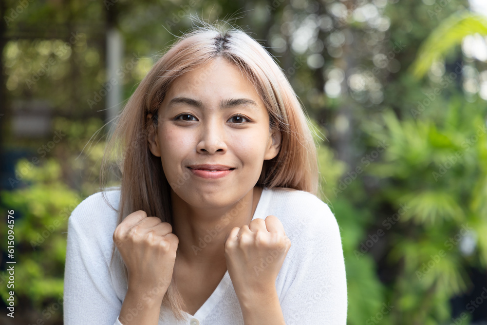 Excited and surprised southeast asian woman with modern hair coloring in outdoor green park Excited and surprised southeast asian woman with modern hair coloring in outdoor green park