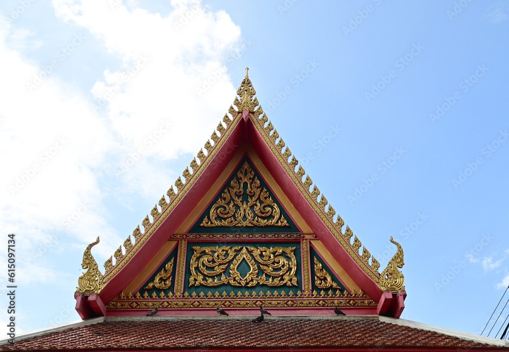 BANGKOK, THAILAND - June 20, 2023 : Part of the Roof of a temple in Thailand. Traditional Thai style pattern on the roof of a temple with Blue Sky Background. BANGKOK, THAILAND - June 20, 2023 : Part of the Roof of a temple in Thailand. Traditional Thai style pattern on the roof of a temple with Blue Sky Background.