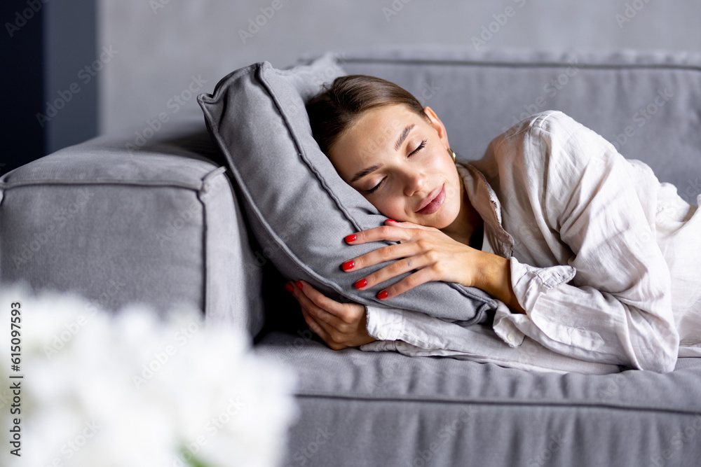 Young attractive woman sleeping on the couch in the living room Young attractive woman sleeping on the couch in the living room