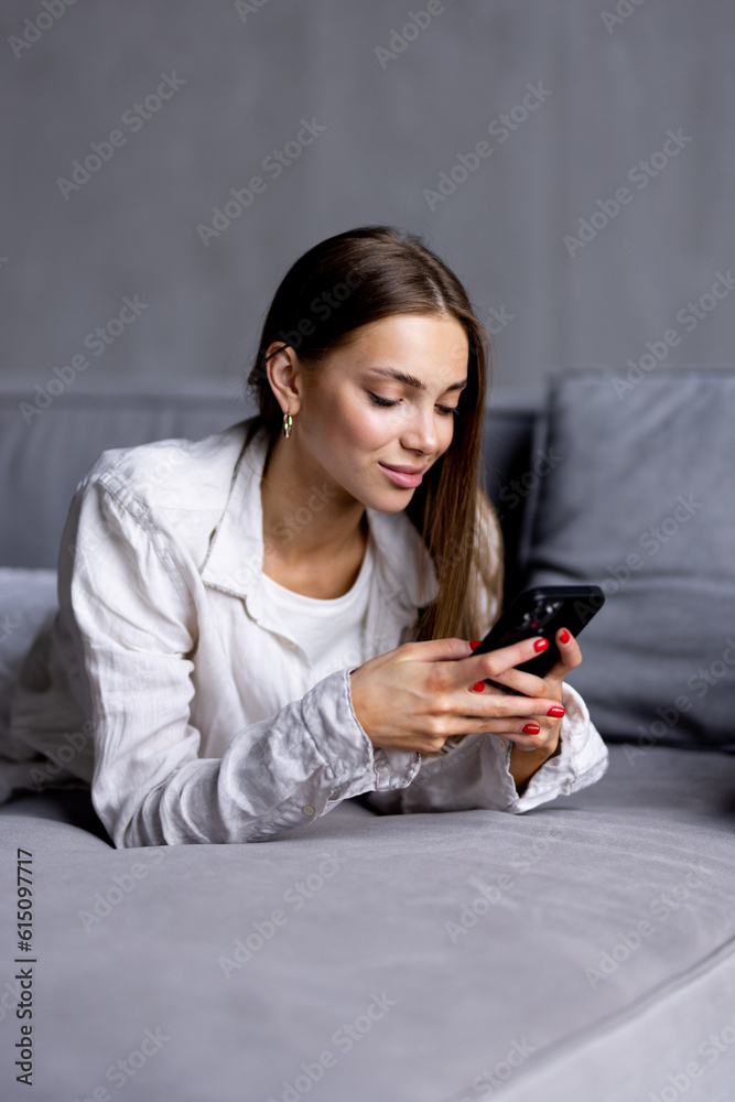 Portrait beautiful young woman use phone or phone on sofa in living room