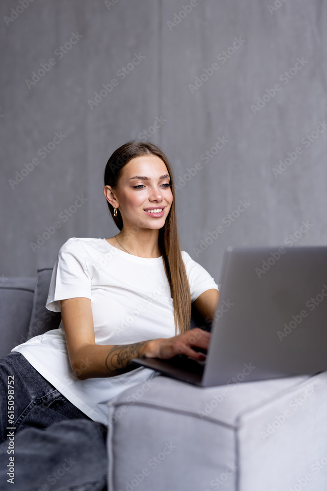Happy pretty woman using laptop sitting on sofa Happy pretty woman using laptop sitting on sofa