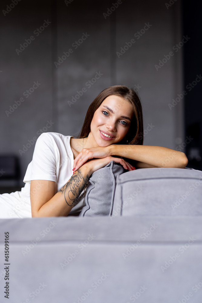 Beauty young woman with white perfect smile looking at camera at home