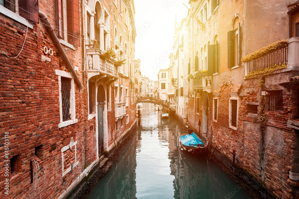 Narrow canal in Venice, Italy with boats