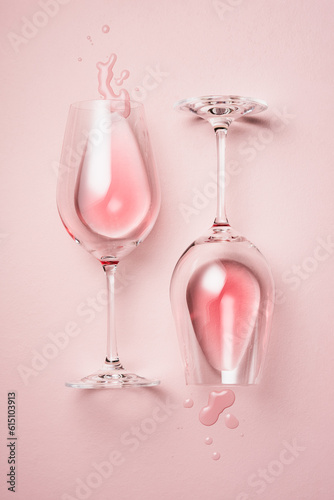 Two glasses of rose wine on a pink background.