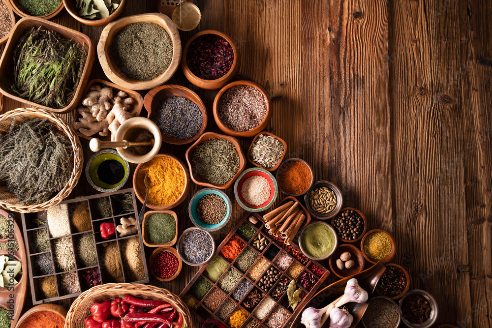 Spices. Collection of spices in bowls on wooden rustic table forming an abstract background.