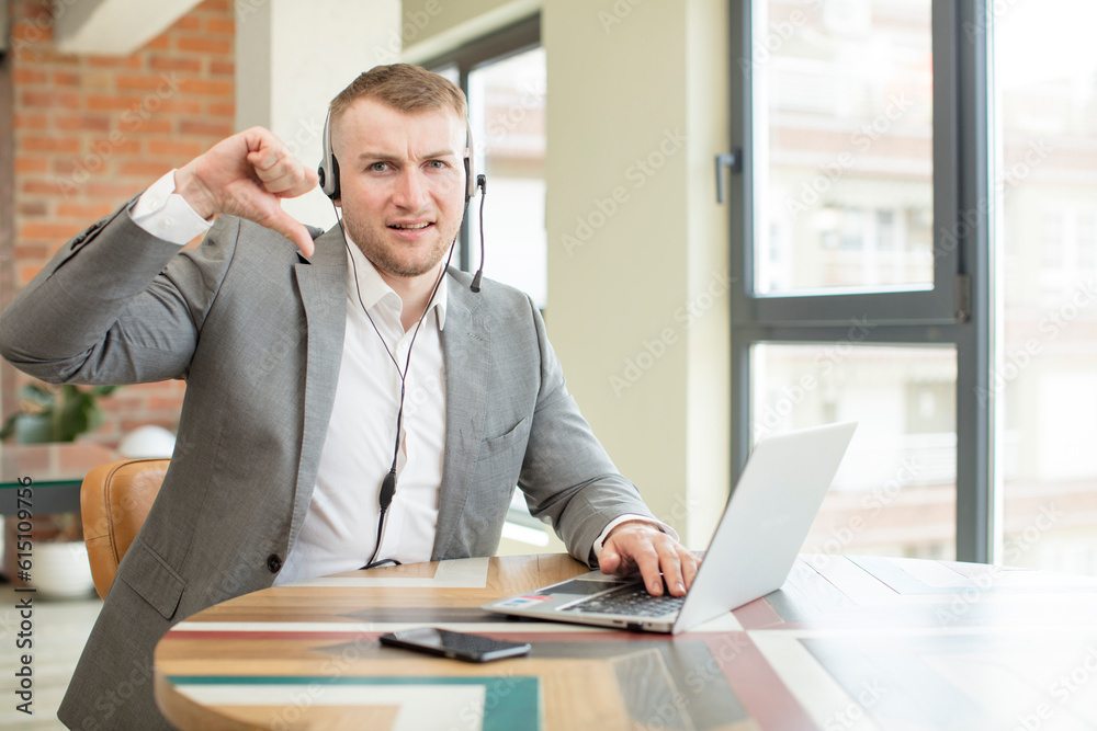feeling cross,showing thumbs down. telemarketer concept feeling cross,showing thumbs down. telemarketer concept