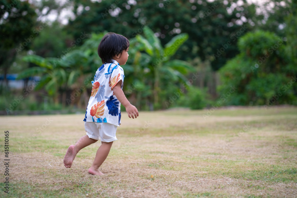 Portrait of happy smiling asian boy laughing green park outdoor with blurred green garden background Portrait of happy smiling asian boy laughing green park outdoor with blurred green garden background