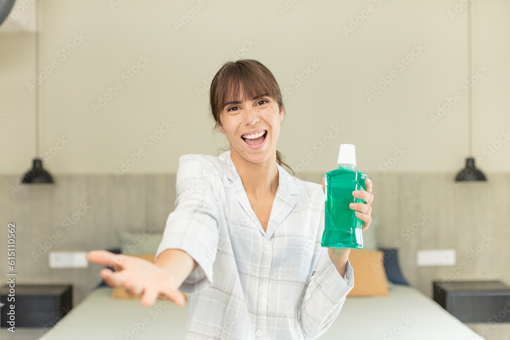 young pretty woman smiling happily and offering or showing a concept. mouthwash concept young pretty woman smiling happily and offering or showing a concept. mouthwash concept