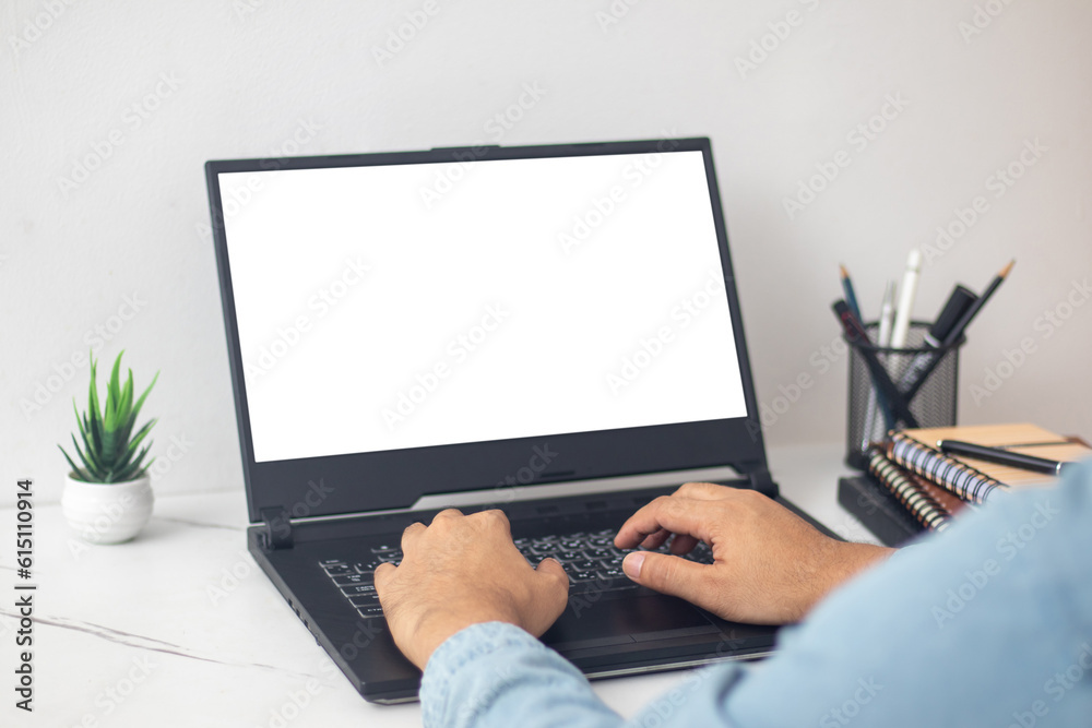 Fototapeta premium man's hands working on laptop at home desk