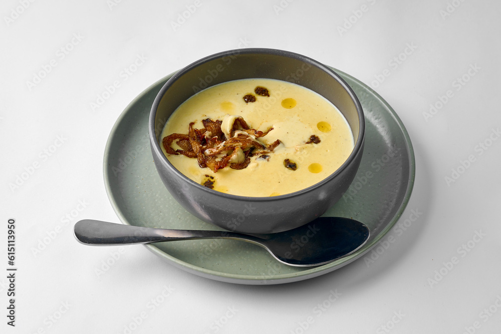 Classic mushroom cream soup with cream in a bowl on a gray background Classic mushroom cream soup with cream in a bowl on a gray background
