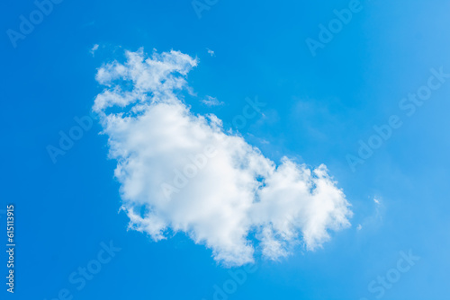 Blue sky background with tiny clouds. White fluffy clouds in the blue sky.