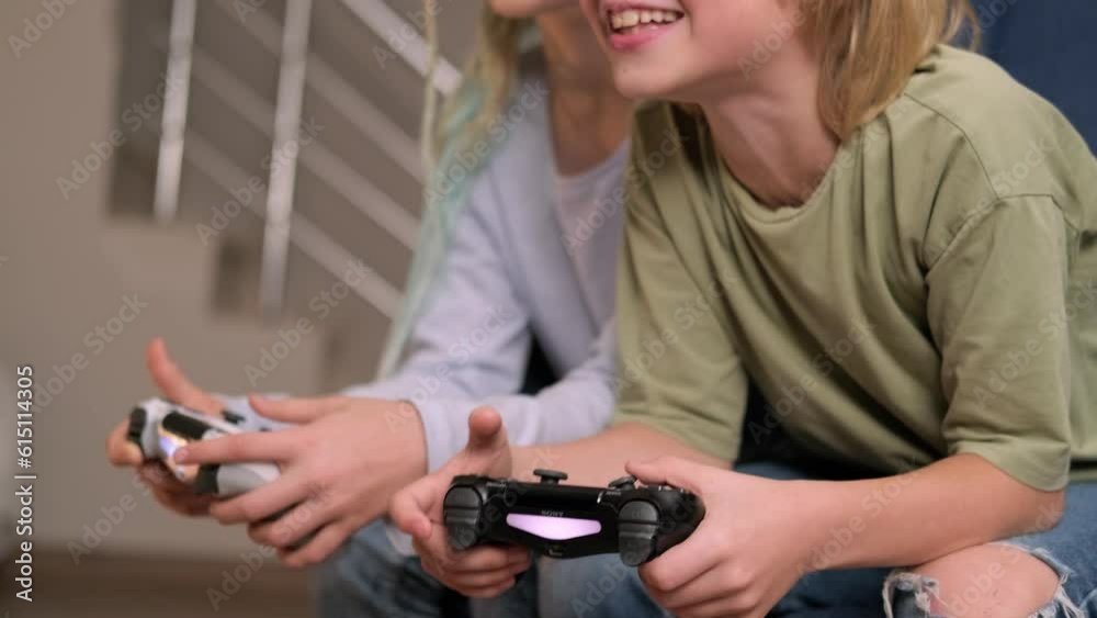 boy and girl playing video game console using joystick or controller while sitting at home, Two children small caucasian brother and sister happy children siblings, real people family leisure concept. boy and girl playing video game console using joystick or controller while sitting at home, Two children small caucasian brother and sister happy children siblings, real people family leisure concept.