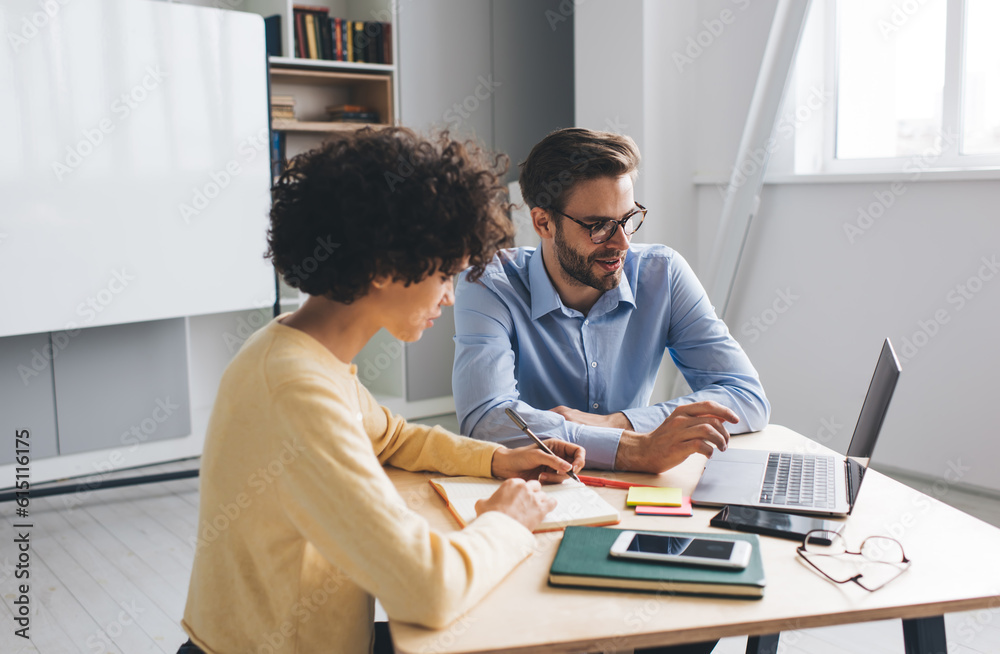 Millenial business man and woman working in office