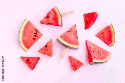 Watermelon fruit sliced with wood ice cream stick on pink background, Watermelon ice cream, watermelon popsicle, Summer concept