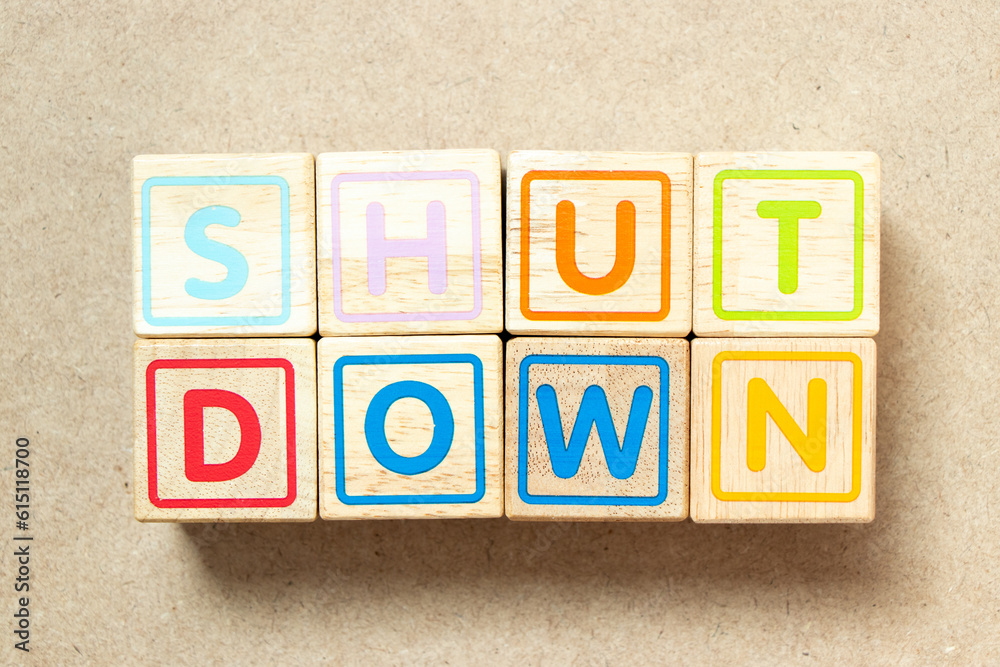 Wooden alphabet letter block in word shut down on wood background Wooden alphabet letter block in word shut down on wood background