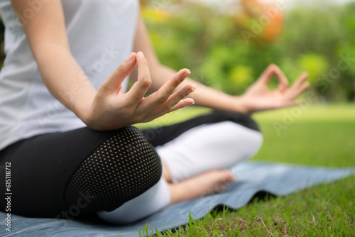 Young female with outdoor activities in the city park, Yoga is her chosen activity.