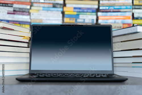 Laptop Computer and stacks of books