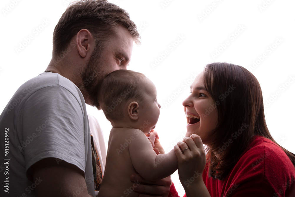 Close up portrait of young parents and baby. Father and mother hug and play with a beautiful little son. The concept of love, happy fatherhood and motherhood. Close up portrait of young parents and baby. Father and mother hug and play with a beautiful little son. The concept of love, happy fatherhood and motherhood.