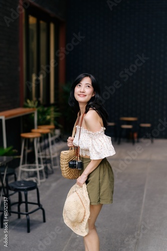 Happy youth asian woman with camera travels street city trip on leisure weekend. Young hipster female tourist sightseeing summer urban Bangkok destination. Asia summer tourism concept.