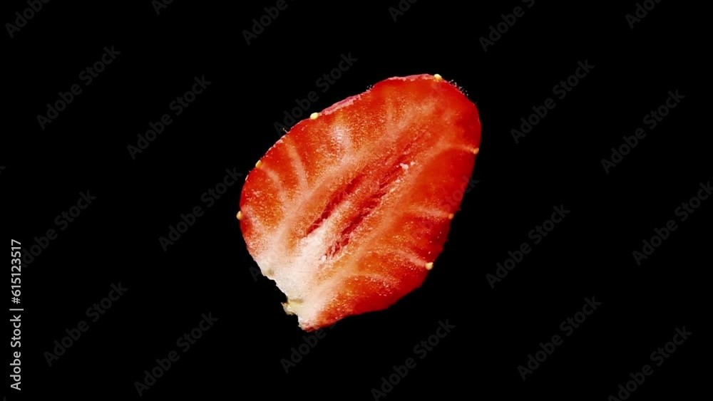 The sliced half of a strawberry rotates on a black background. Fresh juicy garden strawberries close-up. This video can be looped. The sliced half of a strawberry rotates on a black background. Fresh juicy garden strawberries close-up. This video can be looped.