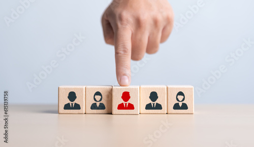 HR or Manager hand choosing man people icons on wooden cube blocks. Business hiring and recruitment selection. Employee lead choice. Career opportunity, Good worker. Human Resource Management concept. photo