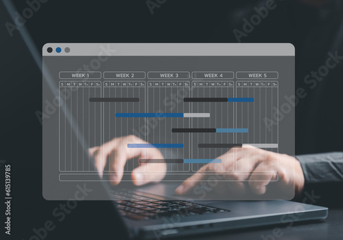 Engineer or Project manager uses laptop computer to make proceeding report concept. Site manager uses planning software to make Gantt chart schedule for updating progress of work and operations tasks.