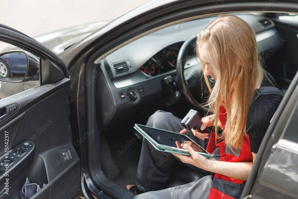 Woman Worker Using Digital Tablet With Empty Screen Sitting In Car doing On-board Diagnostics.