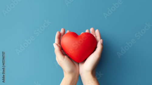 Fényképezés hands hold a red heart on a blue background. ai generative