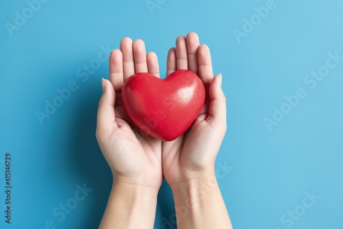 Hands holding heart isolated on blue background, Generative AI
