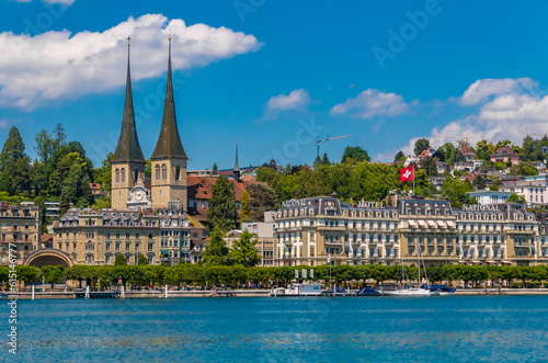 Lovely view of the right lake shore of Lucerne with the Church of St. Leodegar (German: Hofkirche St. Leodegar) on a nice sunny day with a blue sky. It is the parish church of Lucerne.