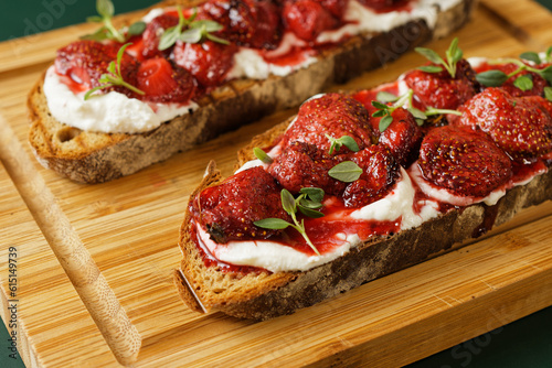 Baked strawberries with honey and thyme atop ricotta-slathered toast.