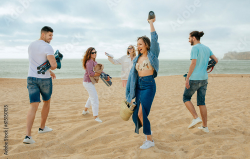 Laughing millennial european and arab people in casual with column, dance, enjoy music, freedom on beach