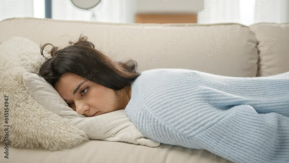 Apathetic bored lady sleeping on couch at home alone. Depression concept. Tired latin girl lying asleep feeling out of energy motivation. Exhausted tired lazy young mixed race woman falls down on sofa Apathetic bored lady sleeping on couch at home alone. Depression concept. Tired latin girl lying asleep feeling out of energy motivation. Exhausted tired lazy young mixed race woman falls down on sofa