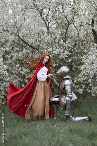 Red-haired girl saying goodbye to the knight in the cherry garden