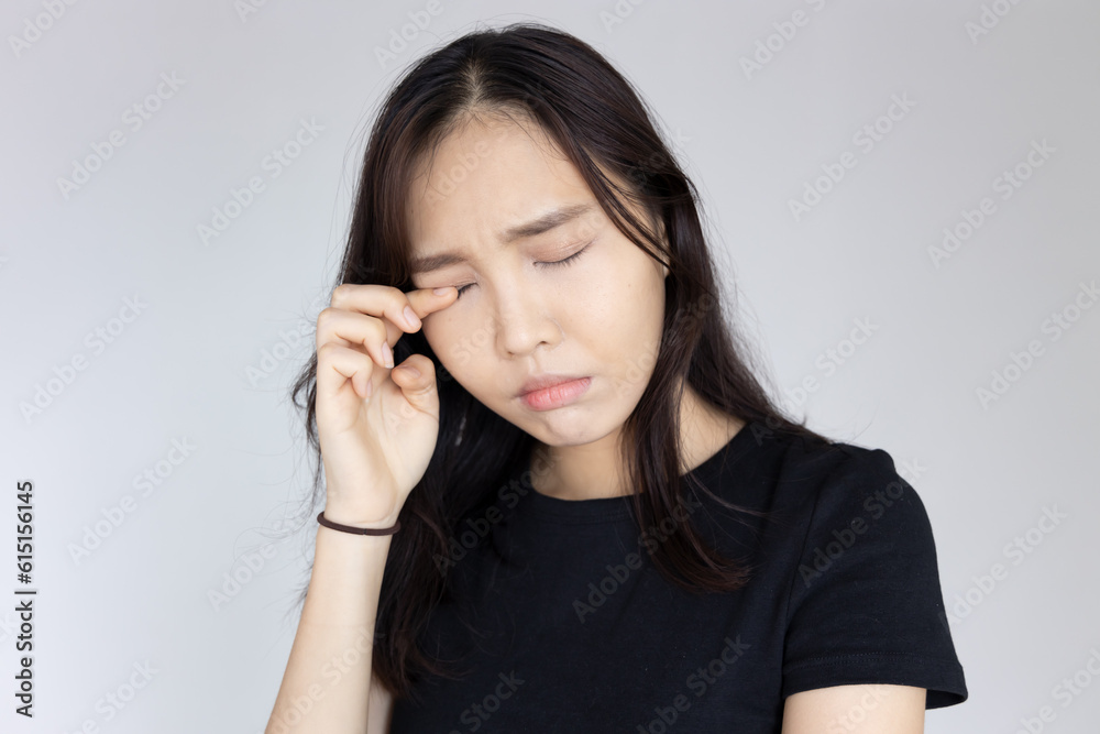 asian woman suffering from irritated eye; concept of optical health care, red eye allergy, eye care, allergic or itching or dry eye inflammation; young adult asian woman model asian woman suffering from irritated eye; concept of optical health care, red eye allergy, eye care, allergic or itching or dry eye inflammation; young adult asian woman model