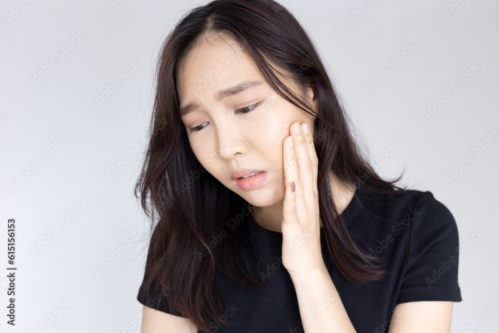 Asian woman suffering from toothache, tooth decay, tooth sensitivity, wisdom tooth pain, cavity, dental care concept Asian woman suffering from toothache, tooth decay, tooth sensitivity, wisdom tooth pain, cavity, dental care concept