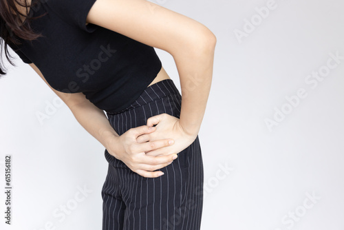 Asian woman suffering from pelvic pain, hip muscle stiffness