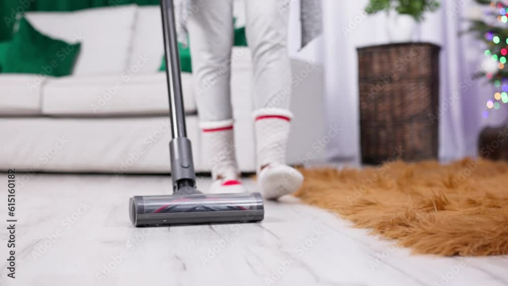 A close-up view while vacuuming the floorboards in the living room.