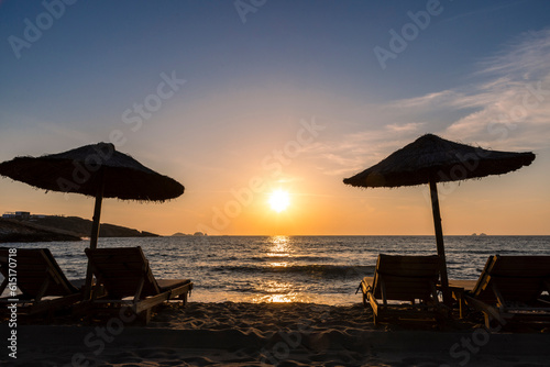 Obraz na płótnie Sun loungers and parasol in sunset on Paros island, Greece w salonie