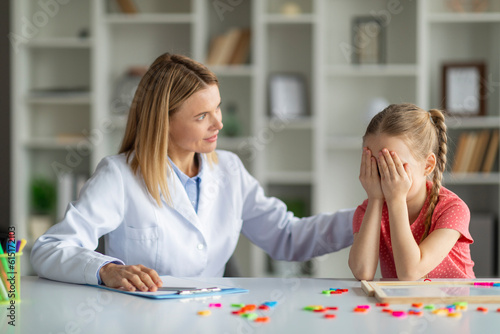 Cognitive Behavior Therapy. Psychotherapist Lady Comforting Crying Female Child photo