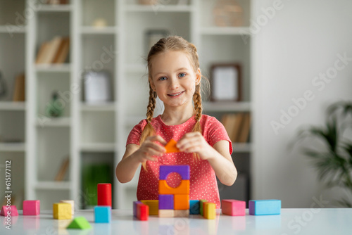 Development Activities. Cute Happy Little Girl Playing With Colorful Wooden Bricks Indoors