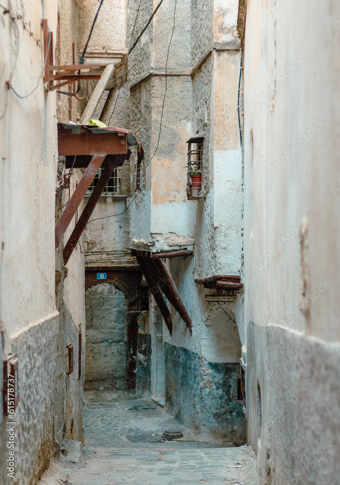 Street scene in the Casbah of Algiers (Alger), Algeria. Stone stairs and ancient Ottoman houses. Narrow street. Typical wooden ottoman achitectural structure.