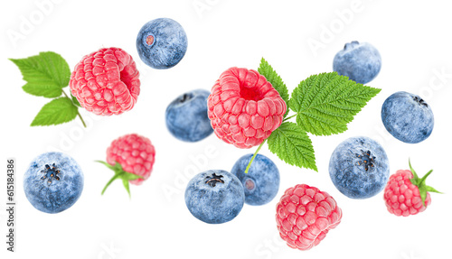 levitation of raspberries and blueberries with leaves on a white isolated background
