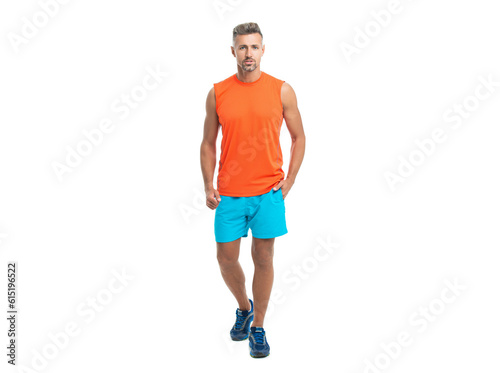 A standing athletic man at the gym studio. athletic man during a yoga class. athletic man posed before a fitness competition. sporty athletic man in tshirt isolated on white background