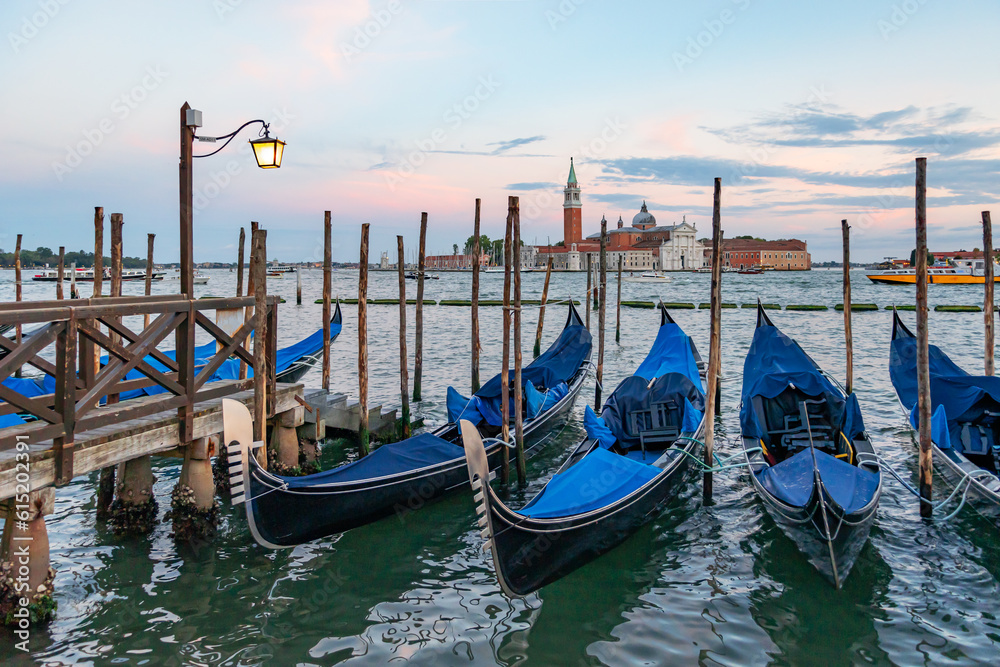 Gondolas in Venice, Italy at sunrise. Venice is a popular tourist destination of Europe.