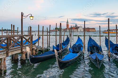Gondolas in Venice, Italy at sunrise. Venice is a popular tourist destination of Europe.