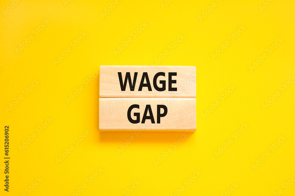 Naklejka premium Wage gap symbol. Concept words Wage gap on wooden blocks on a beautiful yellow table yellow background. Business, support and wage gap concept. Copy space.