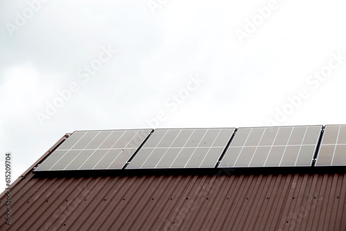 Installing a Solar Cell on a Roof. Solar panels on roof. Historic farm house with modern solar panels on roof and wall. High quality photo