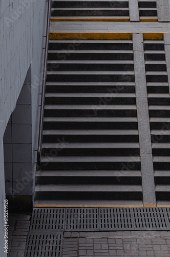 Underground passage. Stairs in an urban landscape. Safety of pedestrians. Design of pedestrian crossings. Traffic management. Emergency exit. Busy city traffic. Pedestrian safety in the city.