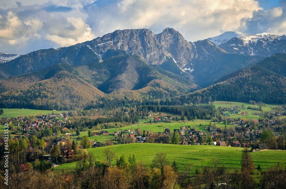 Beautiful country view with mountains in the background. View of the Tatra Mountains and Koscielisko Village in Poland.